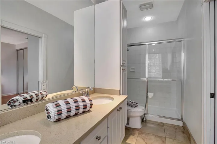 Bathroom with walk in shower, vanity, and toilet