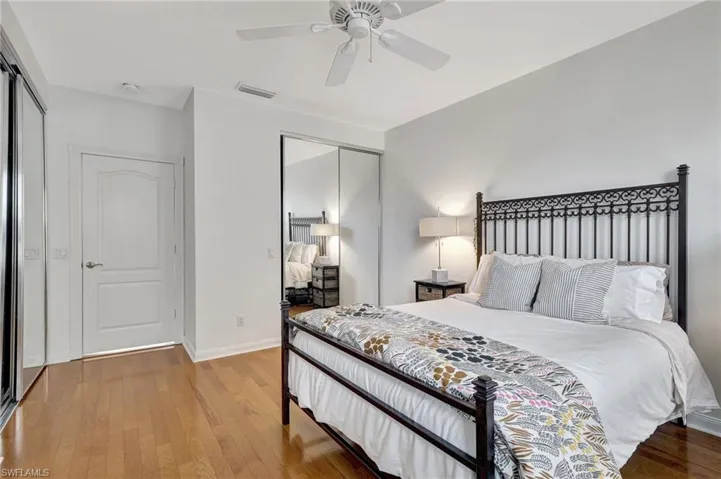 Bedroom with hardwood / wood-style flooring and ceiling fan