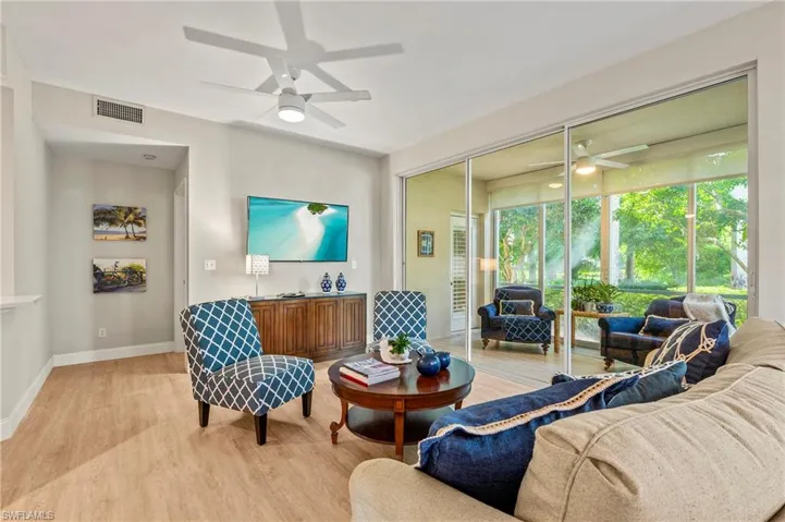Living room with light wood-type flooring and ceiling fan