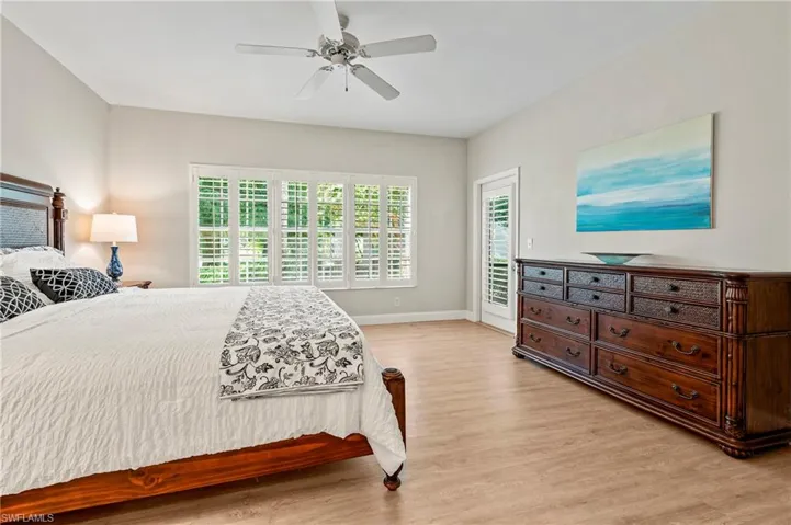 Bedroom with light hardwood / wood-style floors and ceiling fan