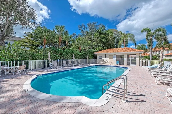 View of community swimming pool with a patio area
