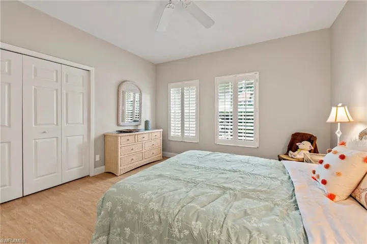 Guest Bedroom featuring light hardwood / wood-style floors, a closet, and ceiling fan