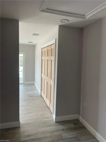 Corridor featuring light wood-type flooring