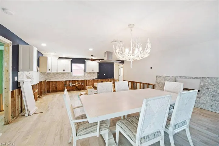 Dining space with a chandelier and light hardwood / wood-style flooring