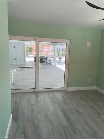 Unfurnished room with hardwood / wood-style floors and ceiling fan
