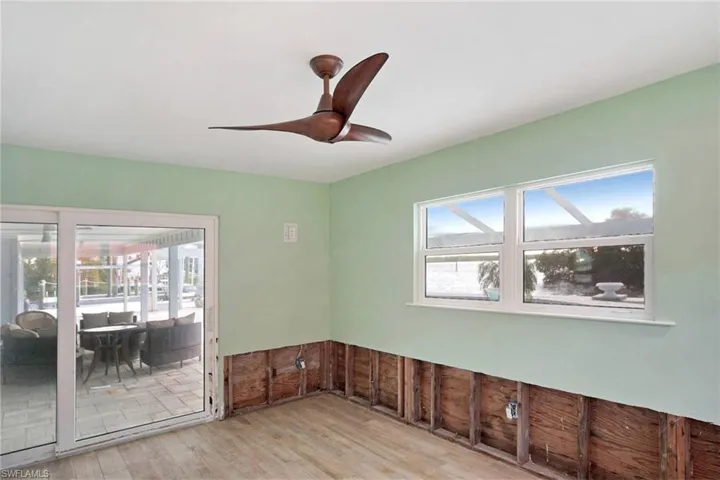 Empty room with ceiling fan and light hardwood / wood-style flooring