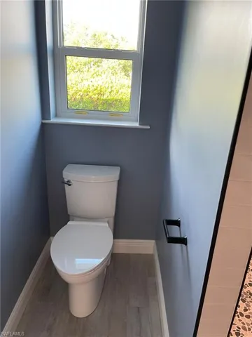 Bathroom featuring toilet and hardwood / wood-style flooring