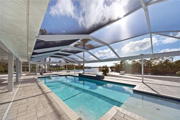 View of swimming pool featuring a lanai and a patio