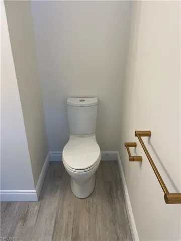 Bathroom featuring wood-type flooring and toilet