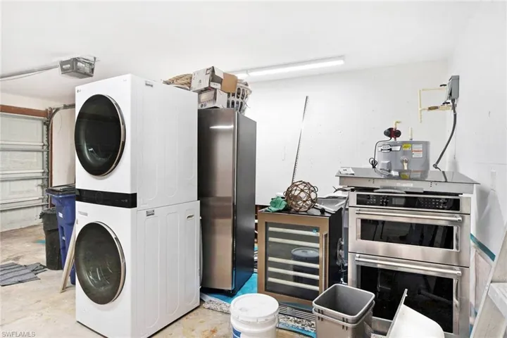 Laundry room with stacked washer and dryer