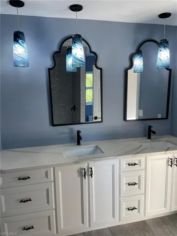 Bathroom with hardwood / wood-style floors and vanity