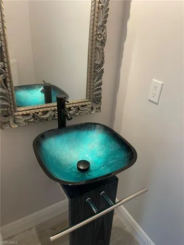 Details featuring vanity and hardwood / wood-style flooring
