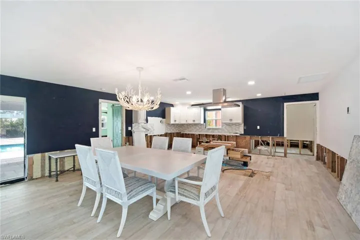 Dining space featuring a notable chandelier and light wood-type flooring