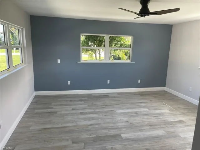 Empty room featuring light hardwood / wood-style floors and ceiling fan