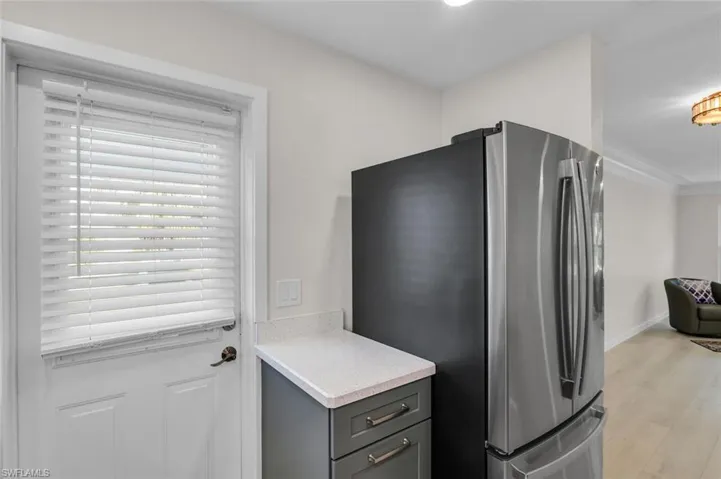 Kitchen with side entrance to carport.