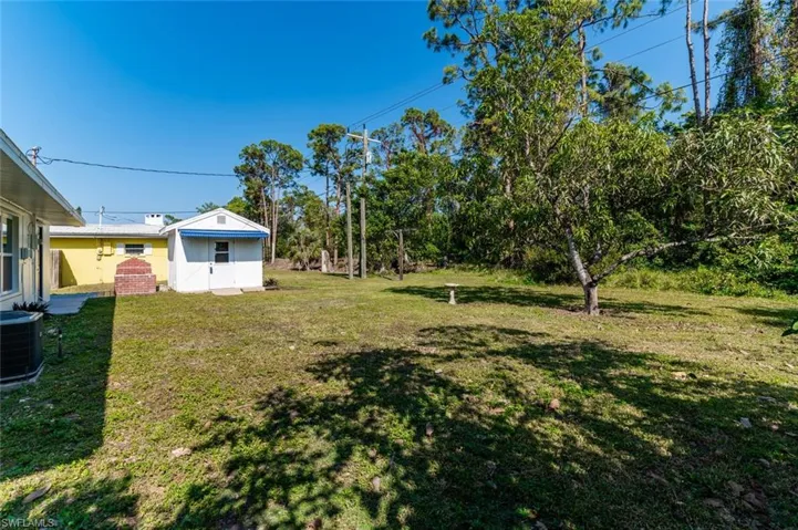 Back Yard with view of Shed and Outdoor Grill