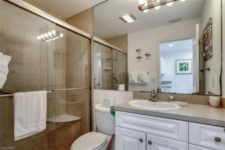 Pre Ian Full bathroom with vanity and a shower stall