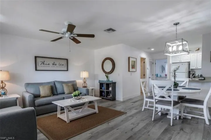 Pre Ian Living room featuring light wood finished floors, a ceiling fan, and recessed lighting