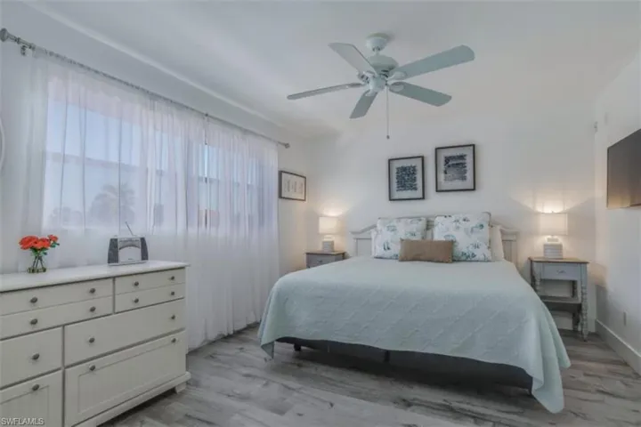 Pre Ian Bedroom featuring light wood-style floors and a ceiling fan
