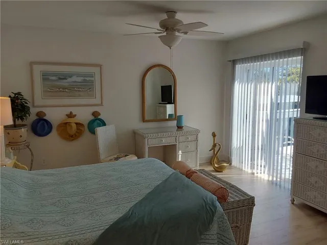 Bedroom with access to exterior,  laminite flooring, and ceiling fan