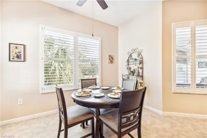 Dining space featuring ceiling fan and light tile patterned floors