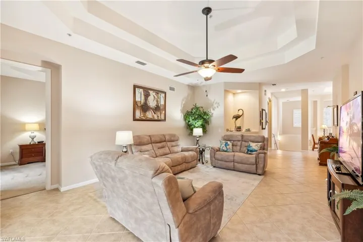 Spacious living room with the staircase in the background.