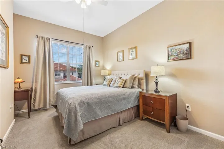 Bedroom featuring light colored carpet and a ceiling fan