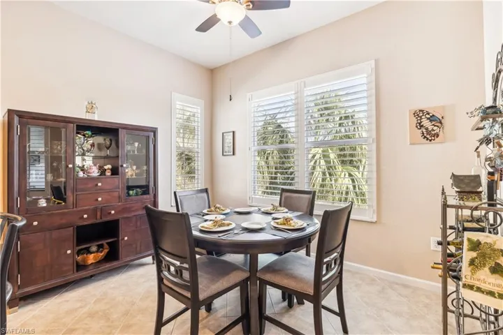 Dining area featuring light tile patterned flooring and a ceiling fan