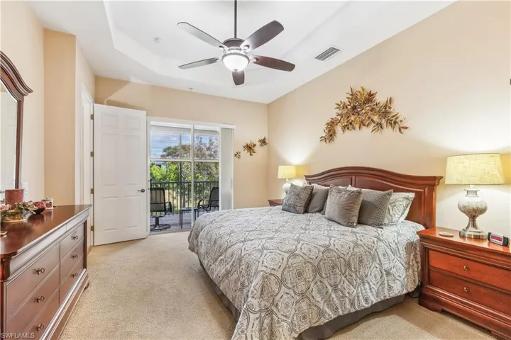 Large primary bedroom with sliders and a view.