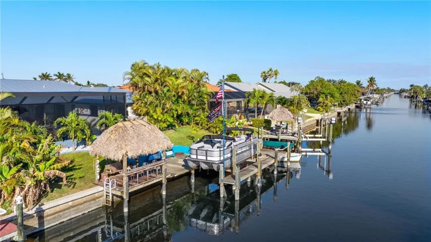 Dock area with a water view and glass enclosure
