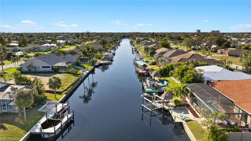 Birds eye view of property with a water view