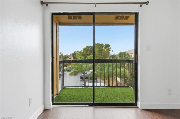 Doorway to outside with healthy amount of natural light and wood finished floors