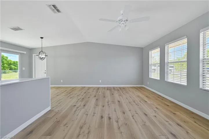 Spacious room with vaulted ceilings and wood-finish flooring