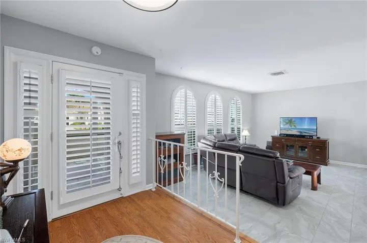 Living area with baseboards and wood finished floors
