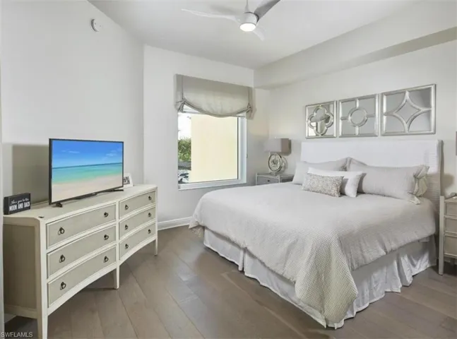 Bedroom with hardwood / wood-style flooring and ceiling fan