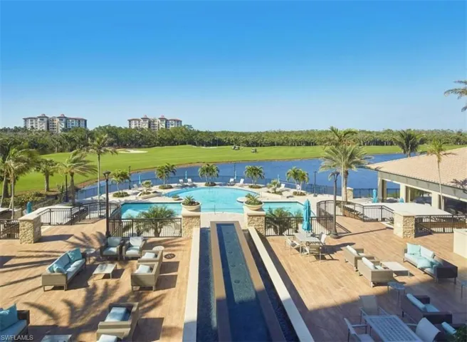 Community pool featuring an outdoor living space, a patio, golf course view, and a water view