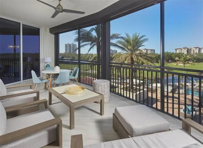 Sunroom featuring a wall of windows and view of golf course