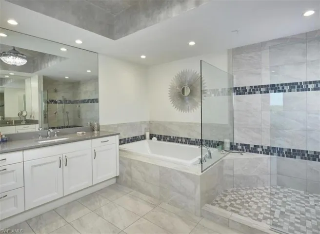 Full bath with a stall shower, vanity, a bath, recessed lighting, and light tile patterned floors