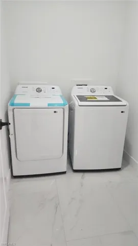 Washroom featuring washer and clothes dryer