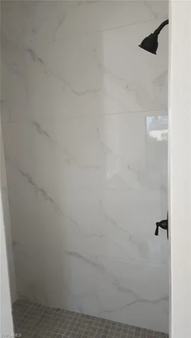 Bathroom featuring tiled shower