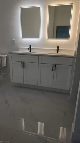 Bathroom featuring vanity and toilet
