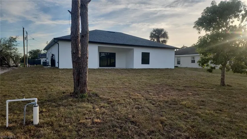 Property exterior at dusk with a lawn