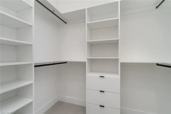 Walk in closet featuring light tile patterned floors