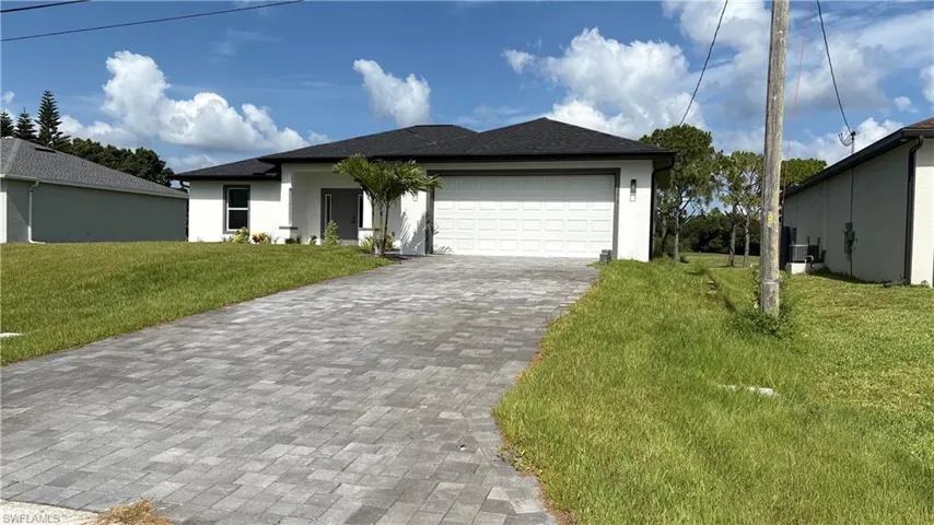 Contemporary single-story residence with a dark shingle roof and white stucco exterior