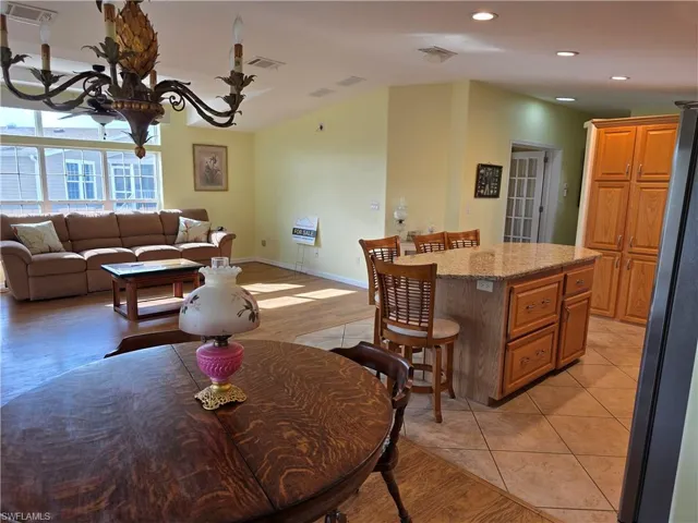 Dining area with light wood-type flooring and recessed lighting