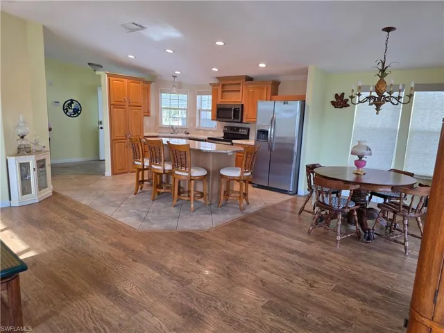 Dining area featuring hanging lights and light wood-style flooring