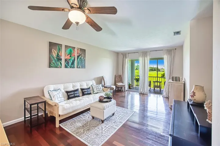 Living area with wood finished floors and ceiling fan