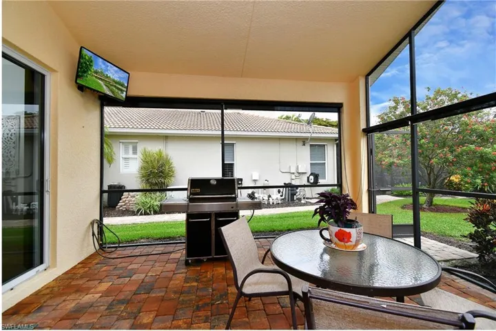 Sunroom / solarium with expansive windows, brick flooring, and healthy amount of natural light