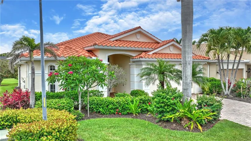 Mediterranean / spanish house with stucco siding, decorative driveway, a tiled roof, and a garage