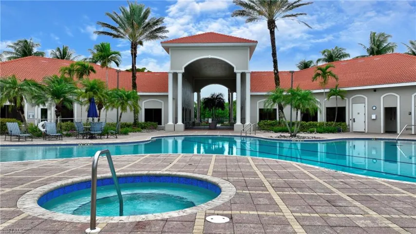Community pool featuring a hot tub and a patio area